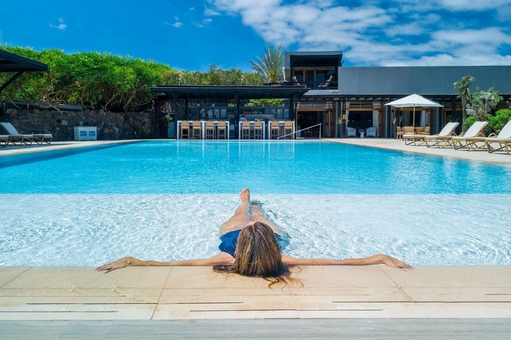 finch bay galapagos luxury hotel guest relaxing in the pool at finch bay hotel, a beachfront escape and one of the luxury hotels in santa cruz.