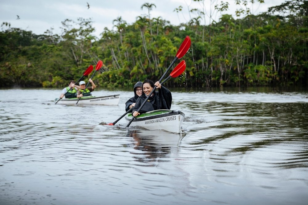 kayaking amazon travelers kayaking on a river in the amazon