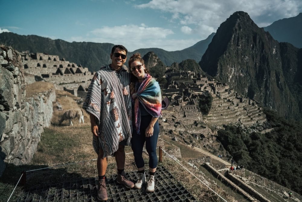 machu picchu visit all year machu picchu a year-round destination. two tourists visiting machu picchu inca ruins