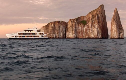 hermes yacht cruising around kicker rock in the galapagos islands.