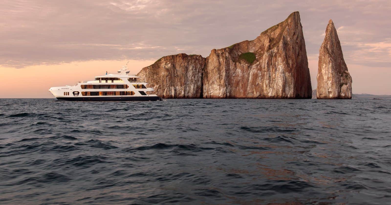 top galapagos cruise activities hermes yacht cruising around kicker rock in the galapagos islands.